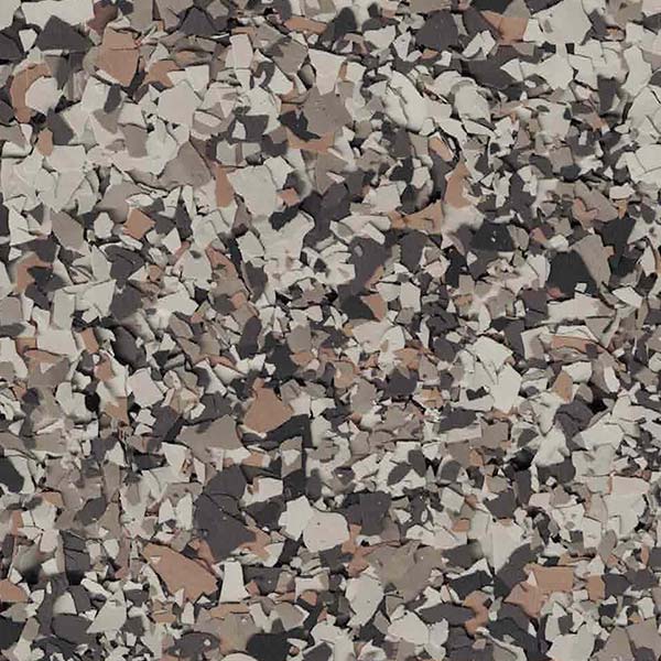 A close-up of a mosaic-like pattern featuring irregular shapes in various shades of gray, black, white, and brown, resembling a camouflage design.