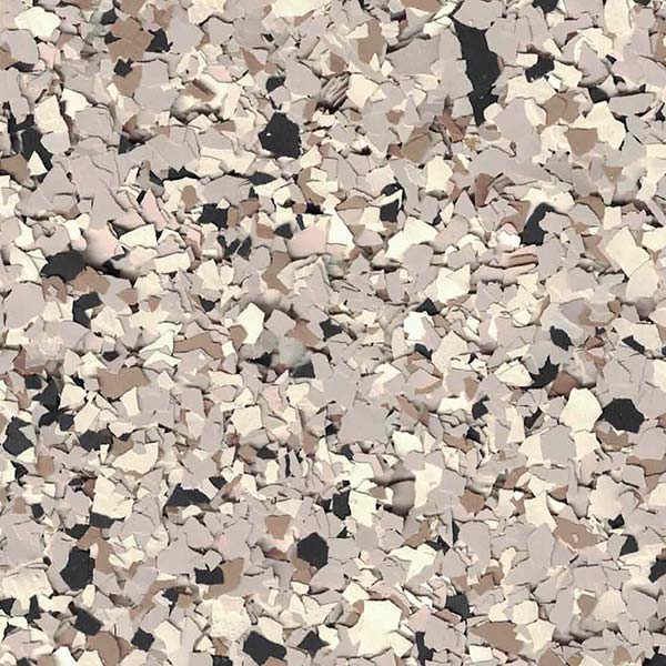 The image displays a close-up view of a textured surface with randomly scattered flakes in shades of beige, brown, and black.