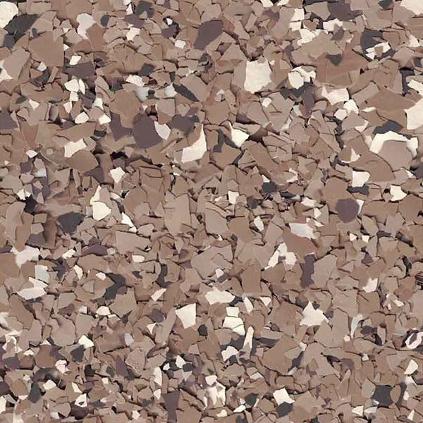 The image displays a close-up view of a surface covered in brown, beige, and white flakes, resembling a textured, patterned material.