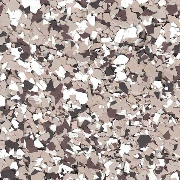 The image shows a close-up view of a textured surface with a pattern of scattered beige, brown, white, and black flakes.