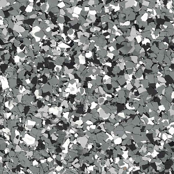 A close-up view of a textured surface featuring a dense pattern of gray, black, and white scattered flakes. No landmarks or buildings are visible.